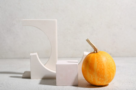 Decorative plaster podiums and pumpkin on white grunge backgroundの写真素材