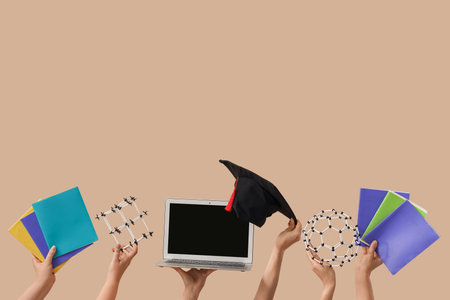 Women with blank laptop, graduation hat, copybooks and molecular models on beige backgroundの写真素材