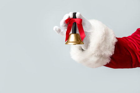 Santa Claus with Christmas bell on gray background