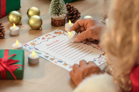 Santa Claus reading letter at table, closeupの写真素材