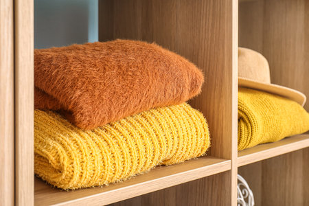 Stack of warm clothes in wardrobe, closeupの写真素材