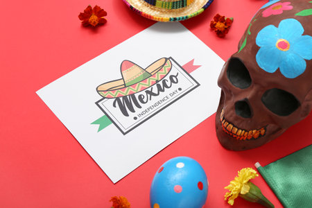 Greeting card with text MEXICO INDEPENDENCE DAY and sugar skull on red backgroundの写真素材