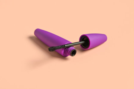 Black mascara in purple tube on pink backgroundの写真素材