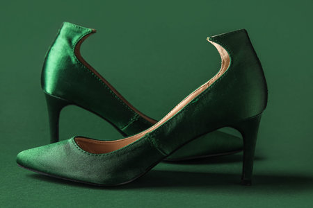 Stylish green high heels on color backgroundの写真素材