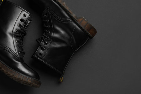 Stylish leather boots on black backgroundの写真素材