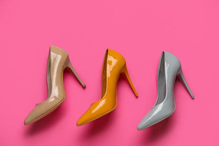 Different stylish high heels on pink backgroundの写真素材