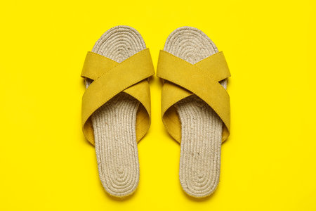 Stylish yellow sandals on color backgroundの写真素材