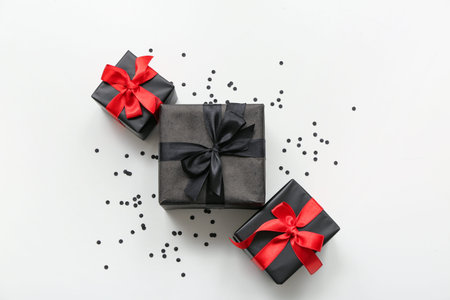 Gift boxes and confetti on white background. Black Friday