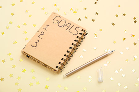 Notebook with empty to do list and confetti on light yellow backgroundの写真素材