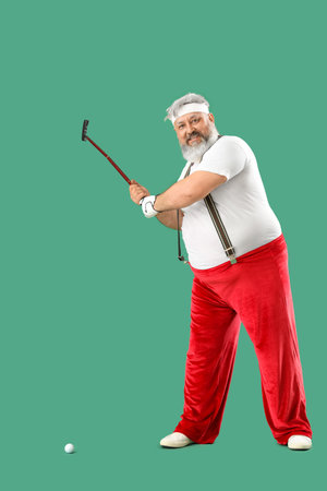 Santa Claus playing golf on green backgroundの写真素材