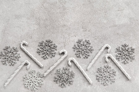 Beautiful snowflakes with candy canes on grunge gray background