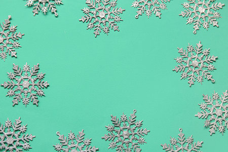 Many beautiful snowflakes on green backgroundの写真素材