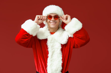 Santa Claus in glasses on red backgroundの写真素材
