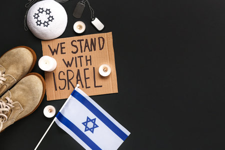 Text WE STAND WITH ISRAEL, flag, candles, dog tags, Jewish hat and military boots on dark backgroundの写真素材