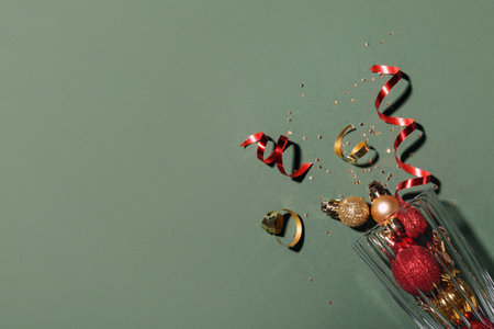 Champagne glass with Christmas decor on green backgroundの写真素材