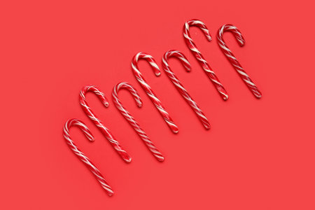 Christmas candy canes on red background