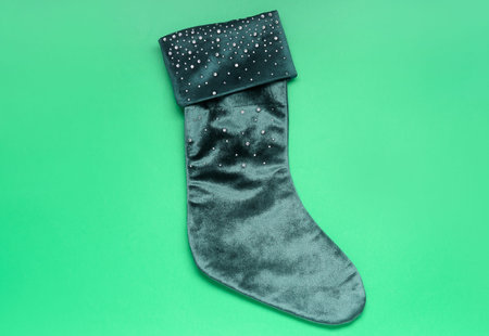 Christmas sock on green background