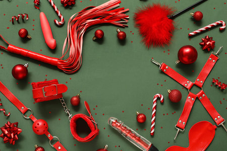 Frame made of different sex toys and Christmas decor on green backgroundの写真素材