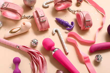 Different sex toys with Christmas decor on beige backgroundの写真素材