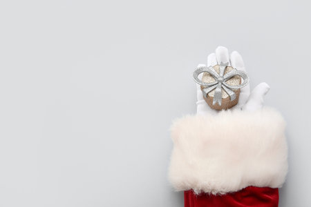 Santa Claus with Christmas gift box on white backgroundの写真素材