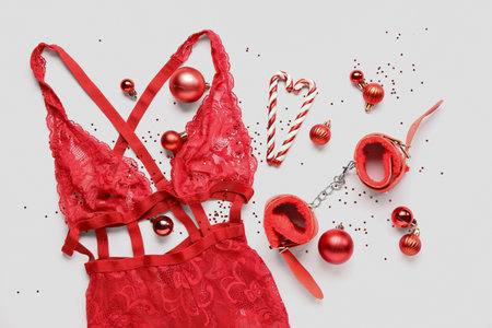 Composition with Christmas sexy underwear, sex toys and Christmas decorations on pink backgroundの写真素材