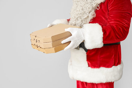 Santa Claus with pizza boxes on white backgroundの写真素材