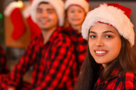 Young woman with her family watching Christmas movie at home, closeupの写真素材