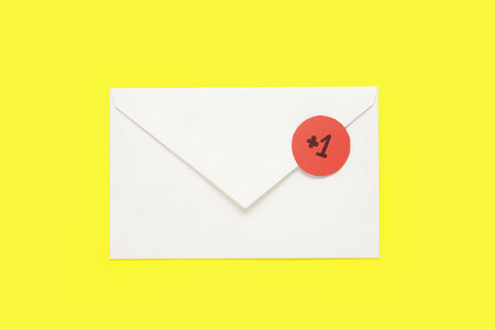 Closed envelope with +1 icon on yellow background. New message