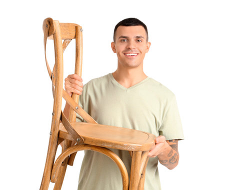 Young man carrying chair on white backgroundの写真素材