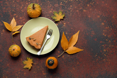 Autumn composition with tasty pumpkin pie on brown backgroundの写真素材