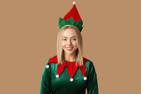 Young woman in elf costume on brown backgroundの写真素材