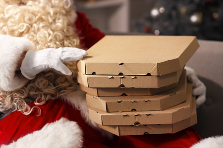 Santa Claus with pizza boxes at home on Christmas Eve, closeupの写真素材