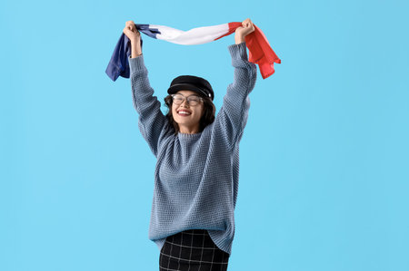 Young Asian woman with flag of France on blue background