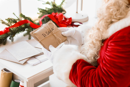 Santa Claus with letters at home on Christmas Eveの写真素材