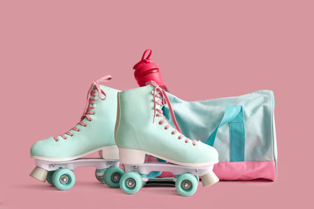 Bag with sports bottle and roller skates on pink background