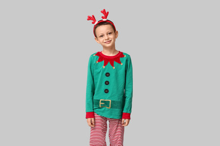 Cute little boy dressed as elf on gray backgroundの写真素材