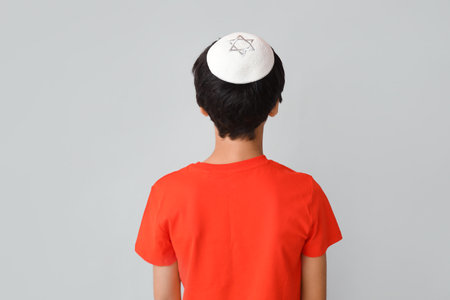 Little Israeli boy in kipa on gray background, back viewの写真素材