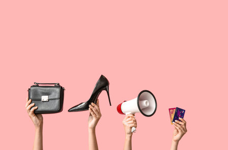 Female hands with women accessories, megaphone and credit cards on pink background. Black Friday saleの写真素材