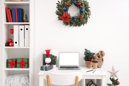 Interior of office with workplace, shelf unit and Christmas decorの写真素材