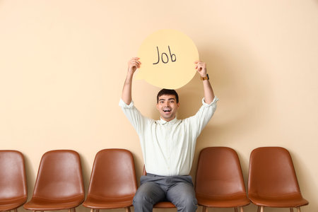 Businessman holding speech bubble with word JOB near beige wallの写真素材