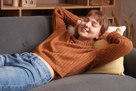 Young woman relaxing on sofa at home