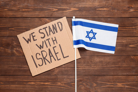 Text WE STAND WITH ISRAEL and flag on wooden backgroundの写真素材