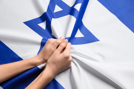 Female hands on flag of Israelの写真素材