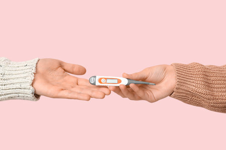 Young people with thermometer on pink background, closeup