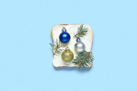 Sandwich with Christmas balls and fir branches on color backgroundの写真素材