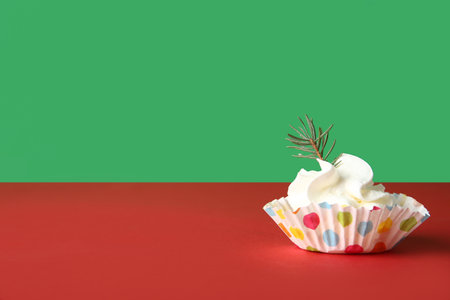 Tasty cake with fir branch on color backgroundの写真素材