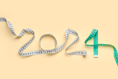 Figure 2024 made of measuring tapes on color background