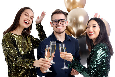 Young friends with champagne on white background. New Year celebrationの写真素材