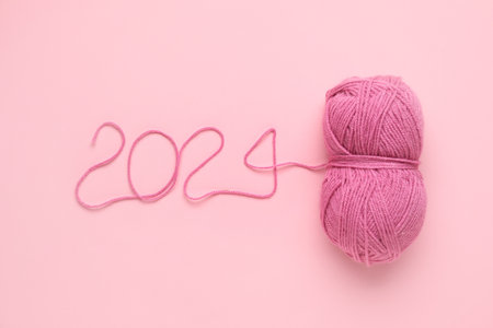 Figure 2024 made of knitting yarn on pink backgroundの写真素材