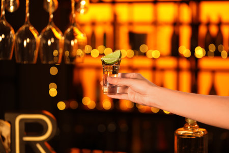 Woman with tequila shot in bar, closeupの写真素材